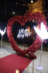 Heart-Shaped Red Floral Proposal Backdrop with Flowers